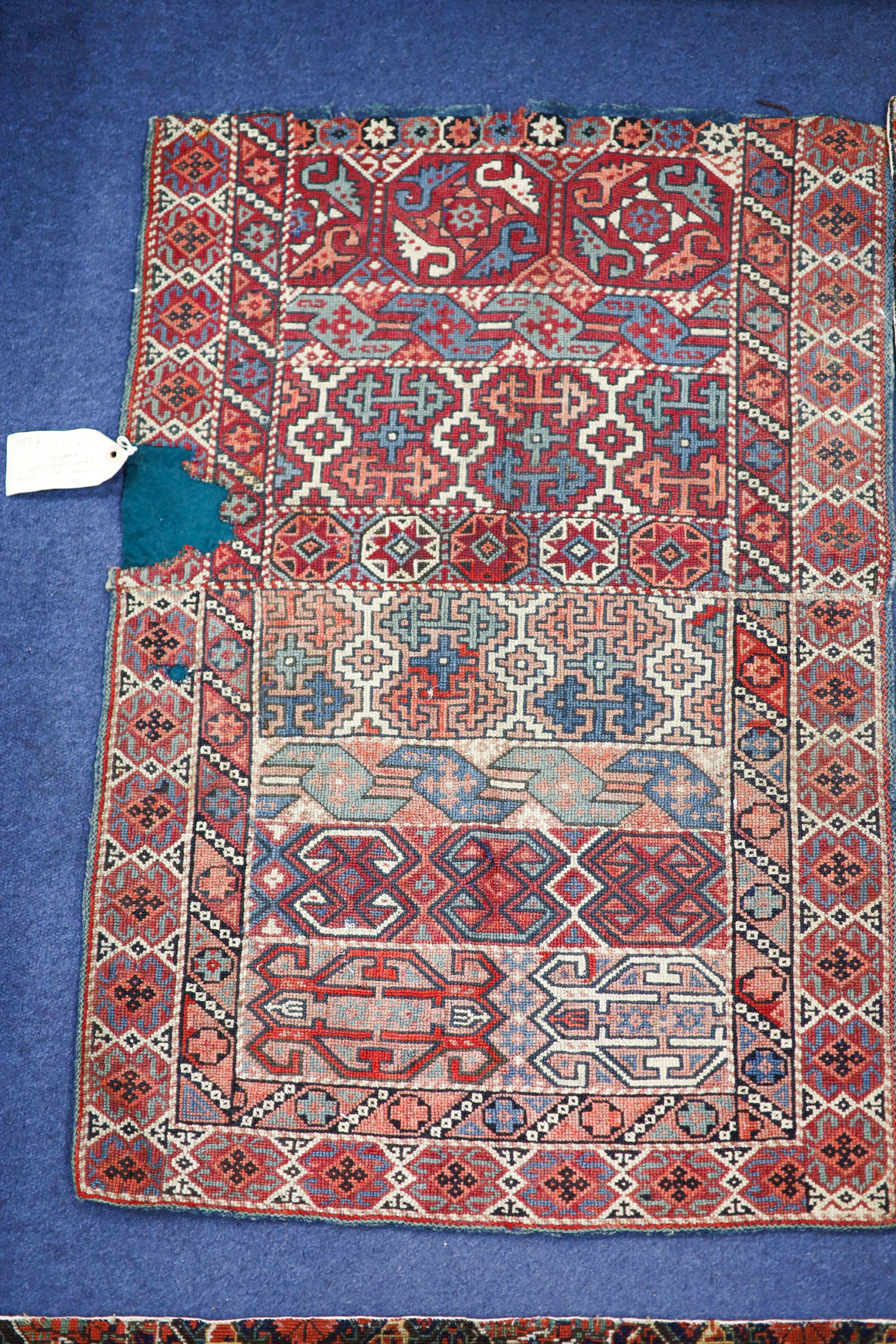 An Ottoman cross stitch embroidered cloth, 84 x 57cm., a pair of Persian antique needlework panels, 80 x 65cm. and a circular small rug, 86cm.